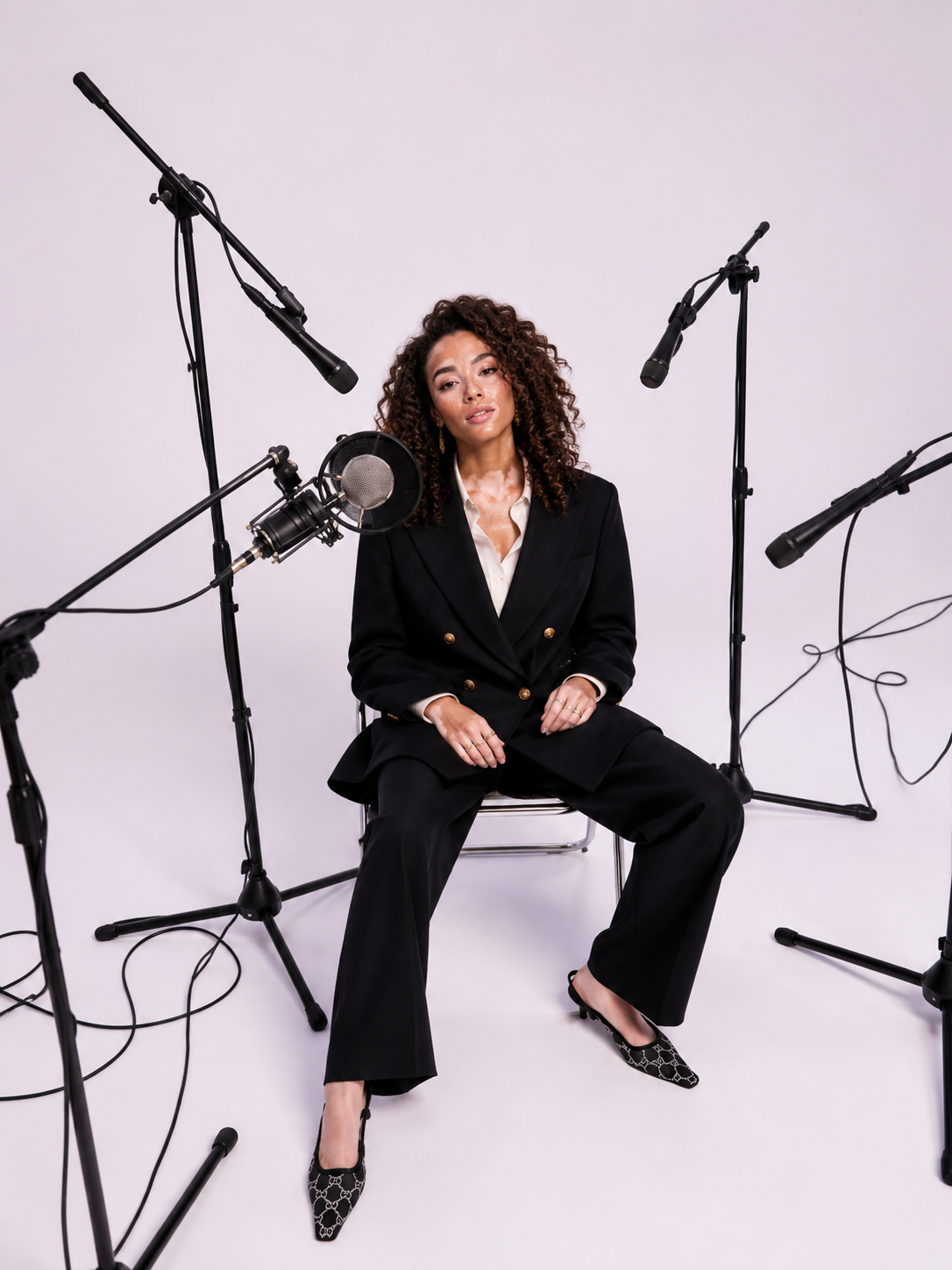 Sophia seated among microphones